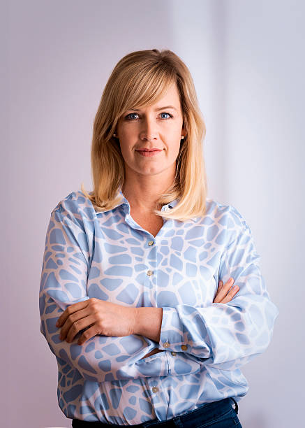 istock Blond haired woman standing against isolated background 2235557643