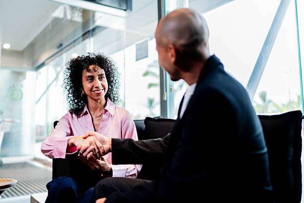 istock Coworkers talking and handshaking at office 2235557861