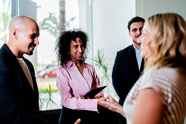 istock Coworkers greeting and talking at office 2235557868
