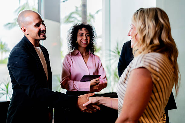 istock Coworkers greeting and talking at office 2235557871