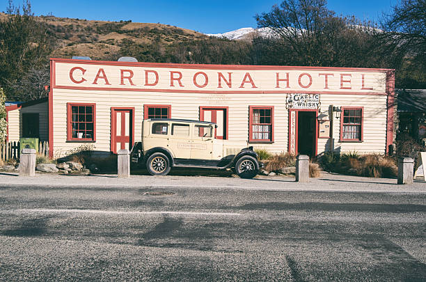 Cardrona, New Zealand - August 14, 2025: Very much an international landmark, this is the Cardrona Hotel on New Zealand's South Island, between the tourist destinations of Wanaka and Queenstown. Parked out front is an equally iconic  1928 Chrysler Model 62.