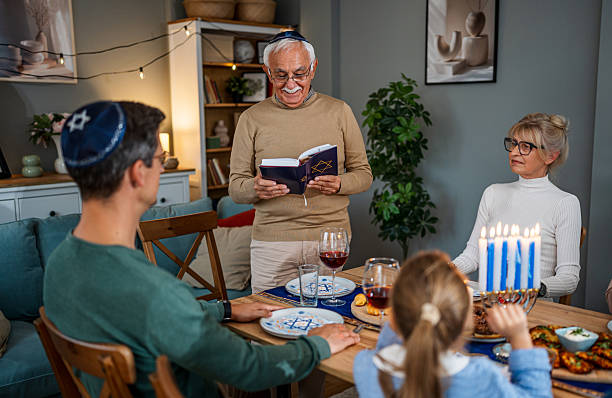 istock Extended family celebrating Hanukkah with traditional dinner 2235560428