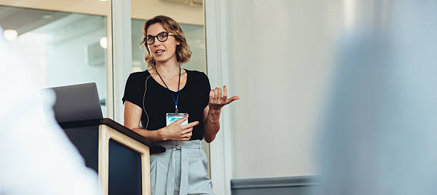istock Woman speaking at business conference with presentation 2235564617