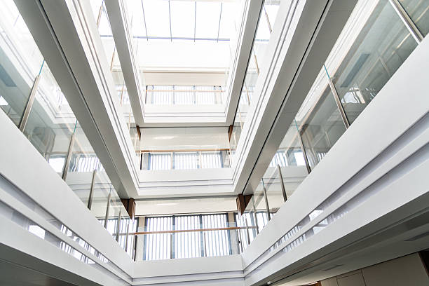 istock Low angle view of modern building with glass ceiling from inside 2235566842