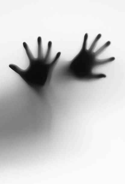 Silhouette of man hands touching glass black and white effect