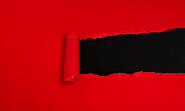 istock Tear open the red paper on the black paper 2235568166