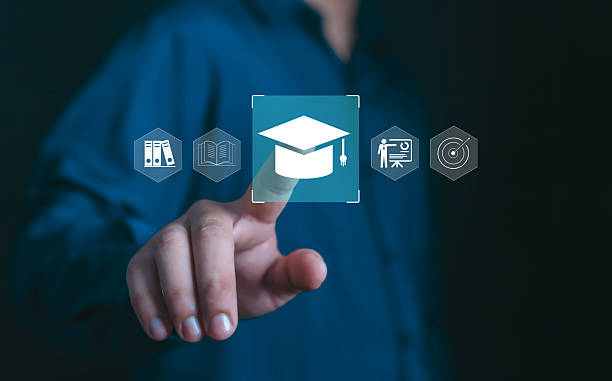 istock Businessman hand touching digital graduation cap icon with online education, e-learning, academic study, training system, smart learning platform concept for modern knowledge and professional growth. 2235571028