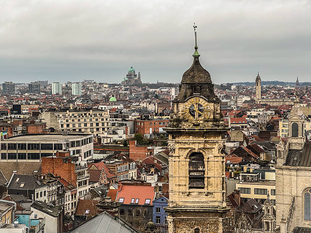 istock Brussels cityscape with clock tower and basilica in the background on a cloudy day 2235573528