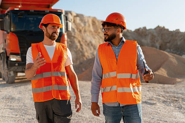 istock Engineers discussing near a dumper truck in a quarry 2235574007