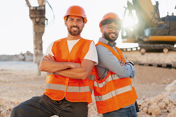 istock Construction workers smiling with crossed arms in a quarry 2235574141
