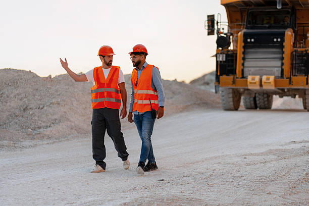 istock Engineers walking and discussing in a quarry next to a dumper truck 2235574256