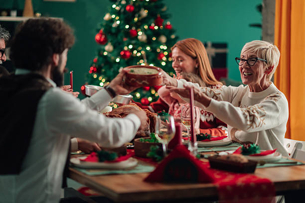 istock Family sharing christmas dinner together around the table 2235575938