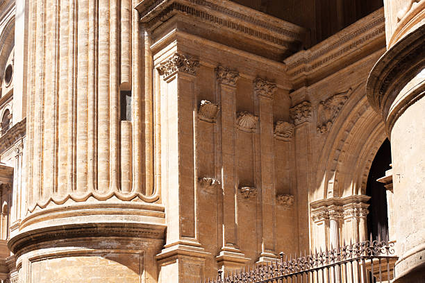 Malaga, Andalusia, Spain. 4 September 2025. Close-up view of cathedral exterior showing stone facade, windows, and decorative columns.