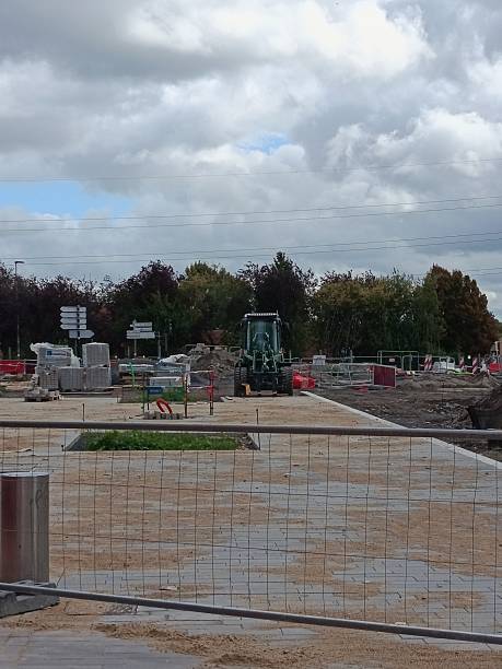 istock Road repair, digging holes, making curbs, planting bushes and trees, bicycle path. 2235579176