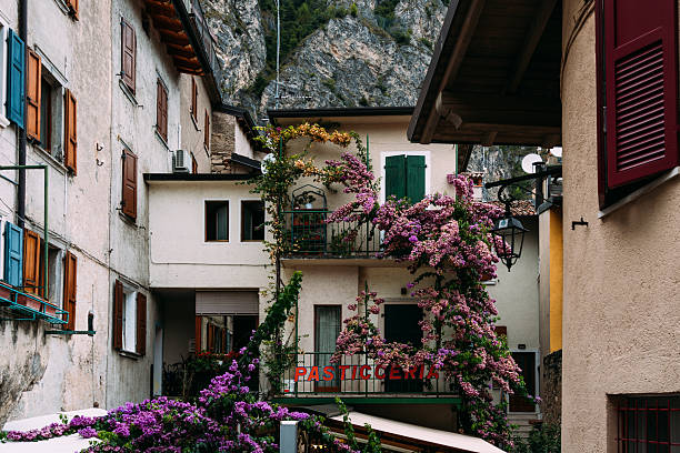 Limone sul Garda, Italy - August 20, 2025: Charming street scene in the picturesque village of Limone Sul Garda, Italy, with traditional buildings and lush greenery.