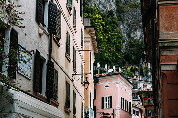 Limone sul Garda, Italy - August 20, 2025: Charming street scene in the picturesque village of Limone Sul Garda, Italy, with traditional buildings and lush greenery.