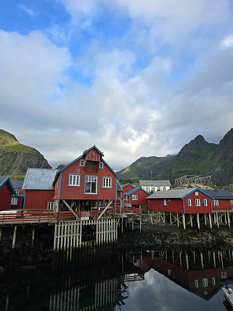 istock Scenic red cabins on stilts with stunning mountain backdrop in Lofoten, Norway 2235581111