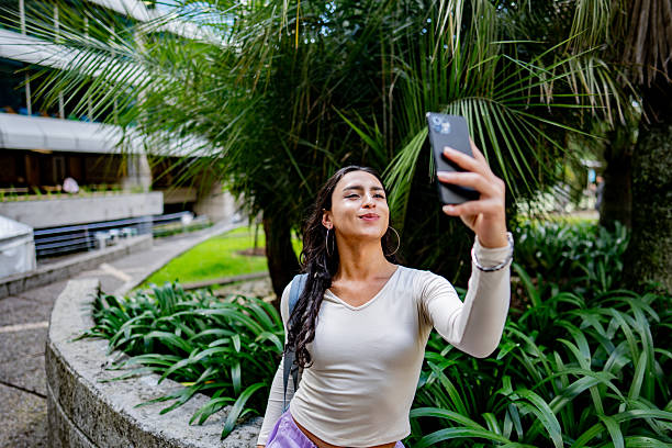 istock Young transgender female taking a selfie or filming on a university campus 2235587128
