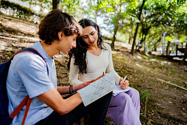 istock Young transgender female talking and studying with friend on university campus 2235587164