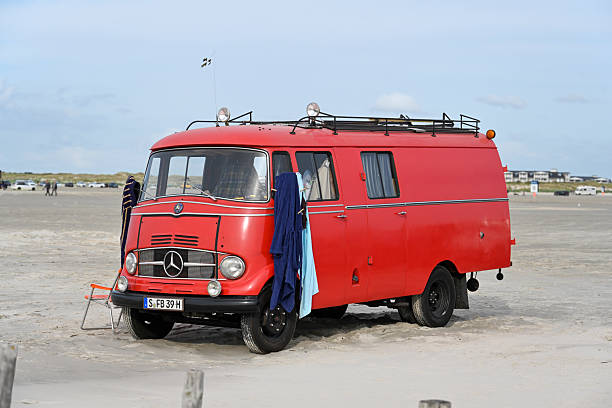 A Mercedes-Benz L 319 (1955 to 1968), a historic former fire truck converted into a camper van on the beach at Sankt Peter-Ording, Schleswig Holstein.
