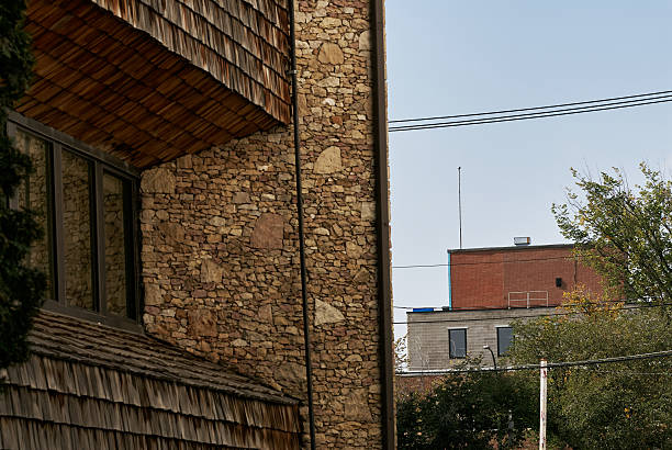 istock Stone wall and urban buildings 2235592366