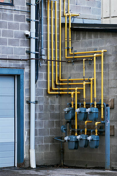 istock Yellow gas pipes on industrial wall 2235592397