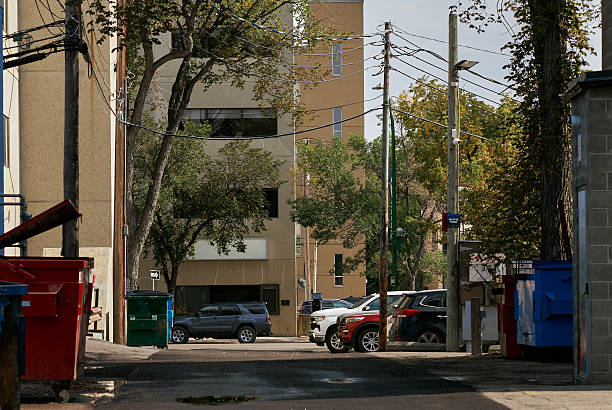 istock Urban alley with garbage bins and power lines 2235592400