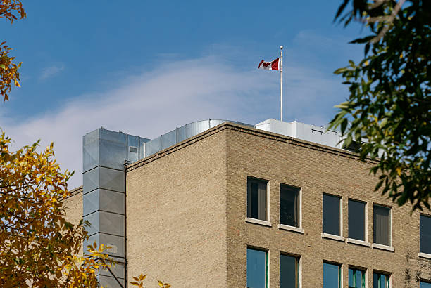 istock Brick building with Canadian flag and autumn leaves 2235593078