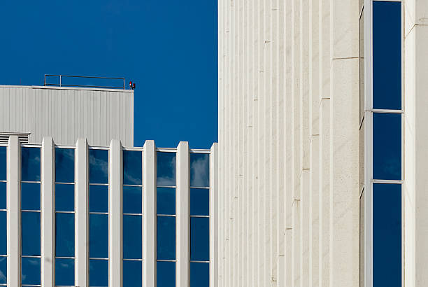 istock Modern skyscraper with vertical glass windows against blue sky 2235593594