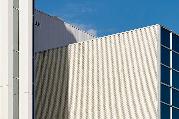 istock Modern skyscraper with vertical glass windows against blue sky 2235593600