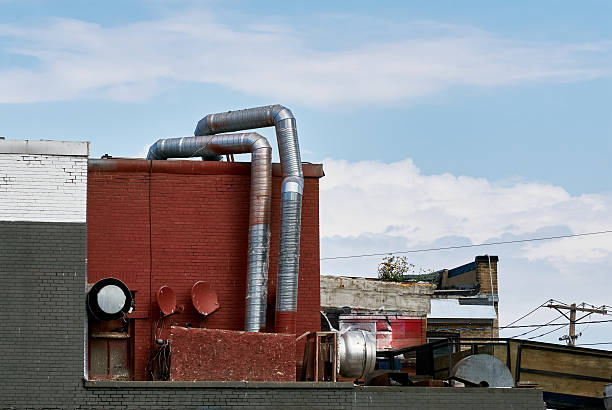 istock Industrial rooftop ventilation pipes with urban graffiti 2235593631