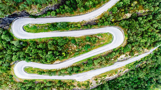 istock Twisting mountain road through lush greenery in Fortun, Norway 2235593847