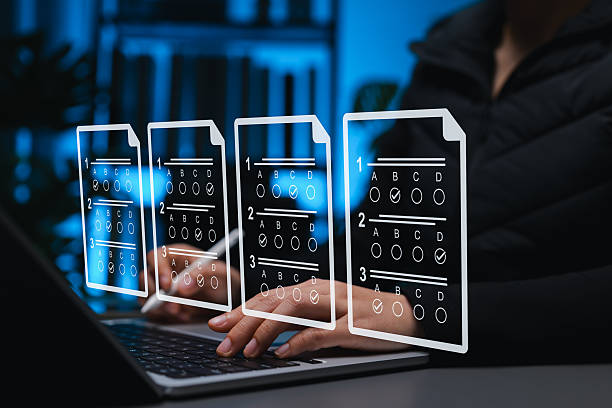 istock Online exam and digital assessment concept, student using laptop with virtual multiple-choice answer sheets represent e-learning, online testing, remote education, academic evaluation, learning tools 2235596187