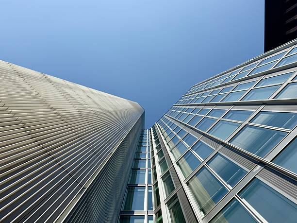 istock Modern skyscrapers and high-rise buildings shot from a low-angle perspective against a clear blue sky 2235596290