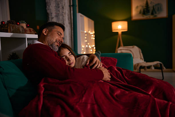 istock Father and daughter sleeping on sofa during Christmas holidays 2235596985