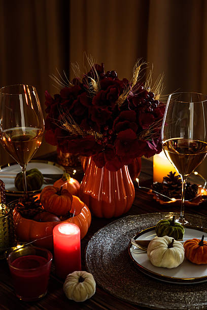 istock Thanksgiving table setting with decorative pumpkins, candles and string lights on dark wooden table 2235597176