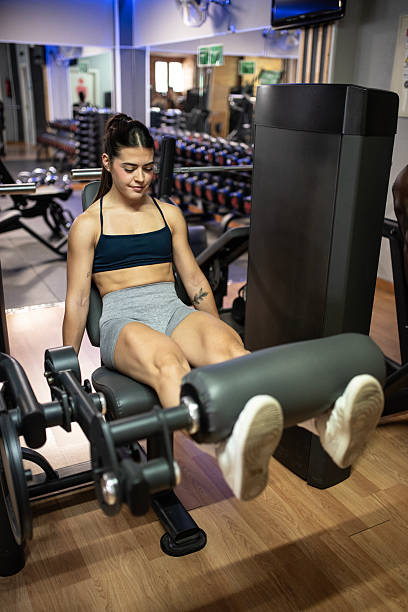 istock Leg training at the gym with pulley machines 2235599538