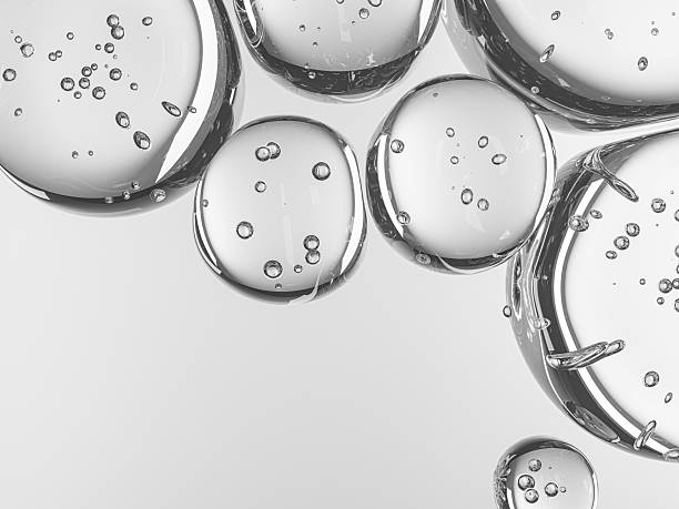 istock Cluster of water bubbles with clear reflections and soft white backdrop. 2235599715