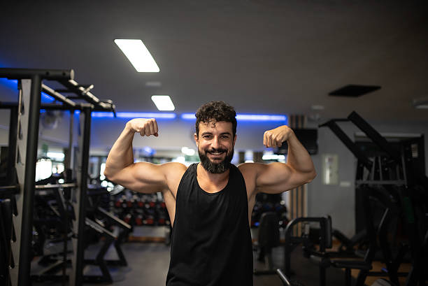 istock Arab man in his 40s does a strength pose at the gym 2235599759