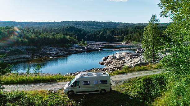 istock Stunning Norway camper van getaway surrounded by lush forest and serene water 2235599984