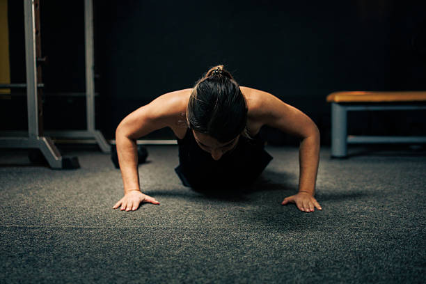 istock Woman Performs Pushups In The Gym 2235600088