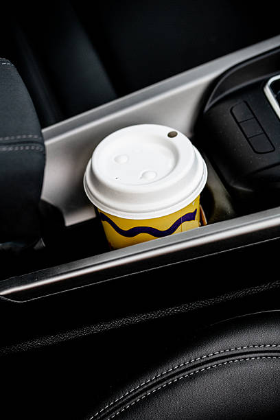 istock Takeaway coffee cup in car cup holder – everyday routine and single-use awareness 2235601739