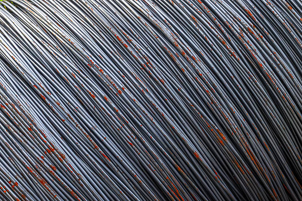Close-up of coiled metallic wires with rust spots.