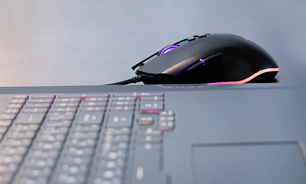istock An illuminated gaming mouse, LED lights, colorful lights, wire mouse, digital gadget, fun time, e sport, gaming mouse concept, E Sport commercial 2235604442