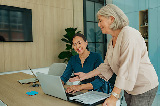 istock Discussion between two professional women in a modern office setting focused on business planning and cooperation 2235606478