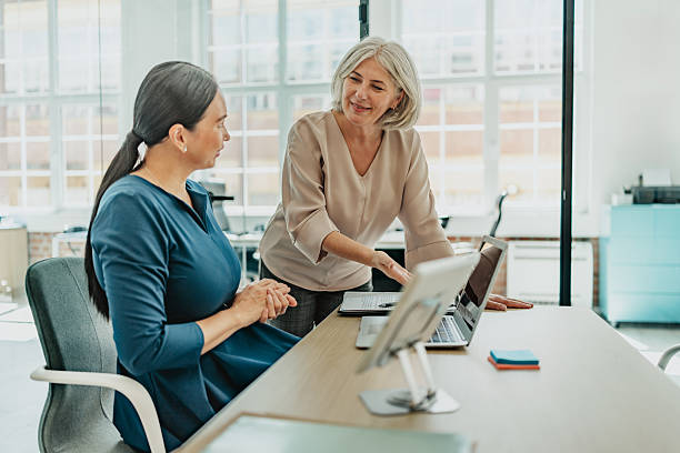 istock Senior women collaborating in a modern office setting while discussing new business strategies and plans 2235610650