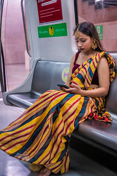 istock Indian girl using a mobile phone in a subway train, India 2235611394