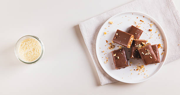 istock Chocolate nut protein bars on a plate on a table top view web banner 2235611546