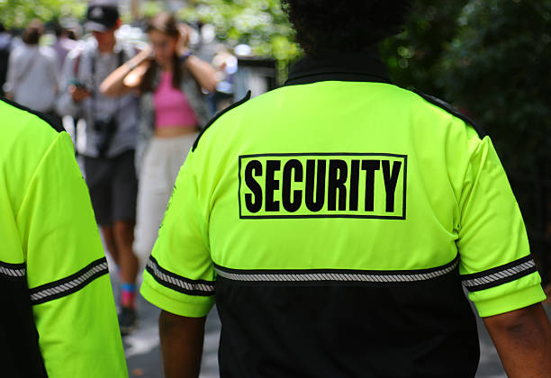 security Word on the fluorescent vest of a security guard while patrolling a city park