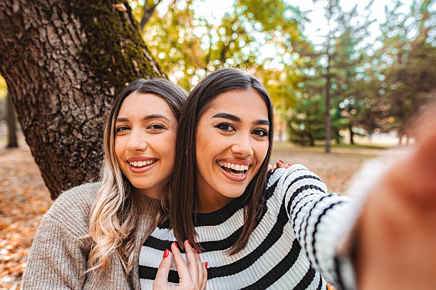 istock Two young women taking a selfie in autumn park 2235613841